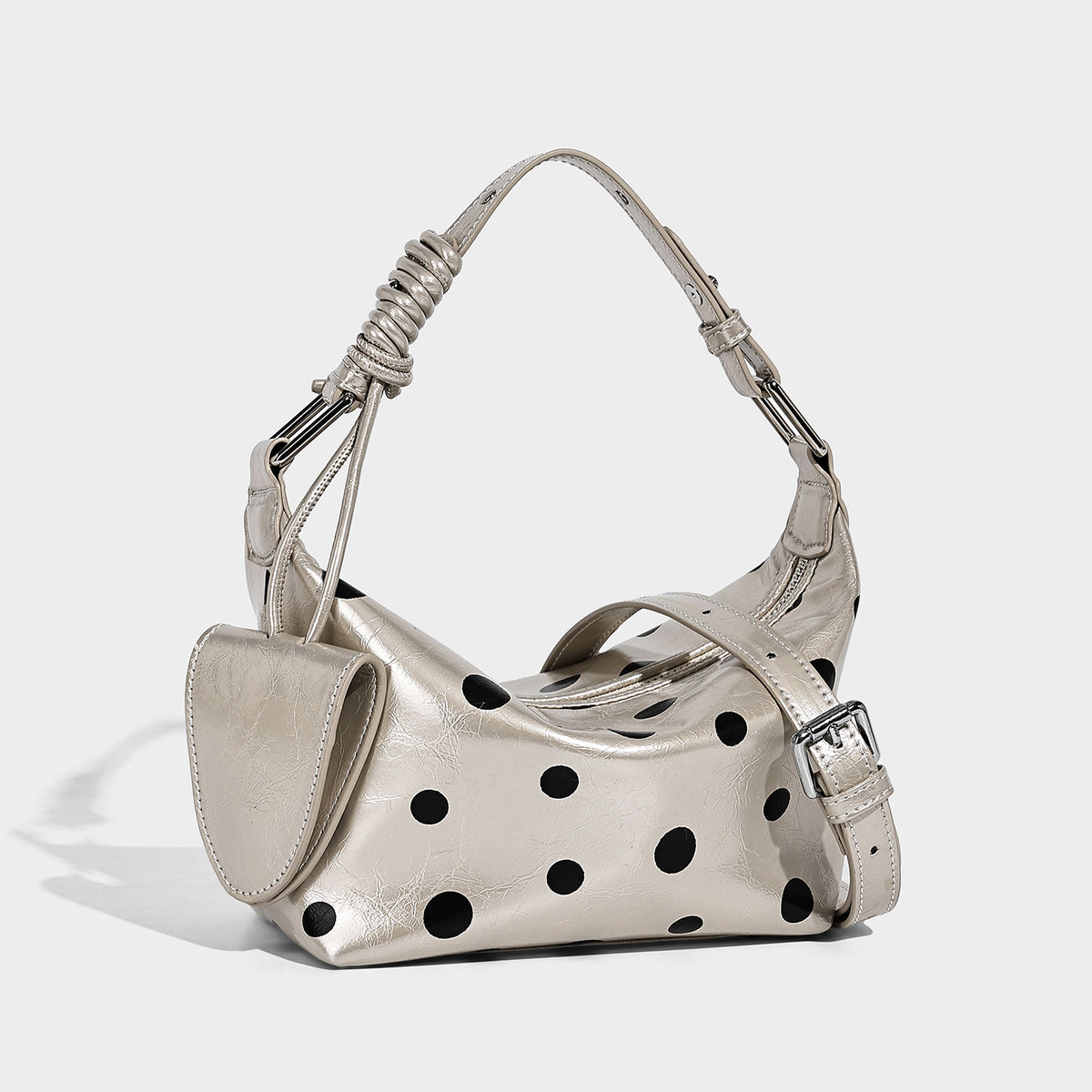 Polka-dot gloss leather-look shoulder bag with attached mini front pouch, top zip closure, and adjustable strap, detail view