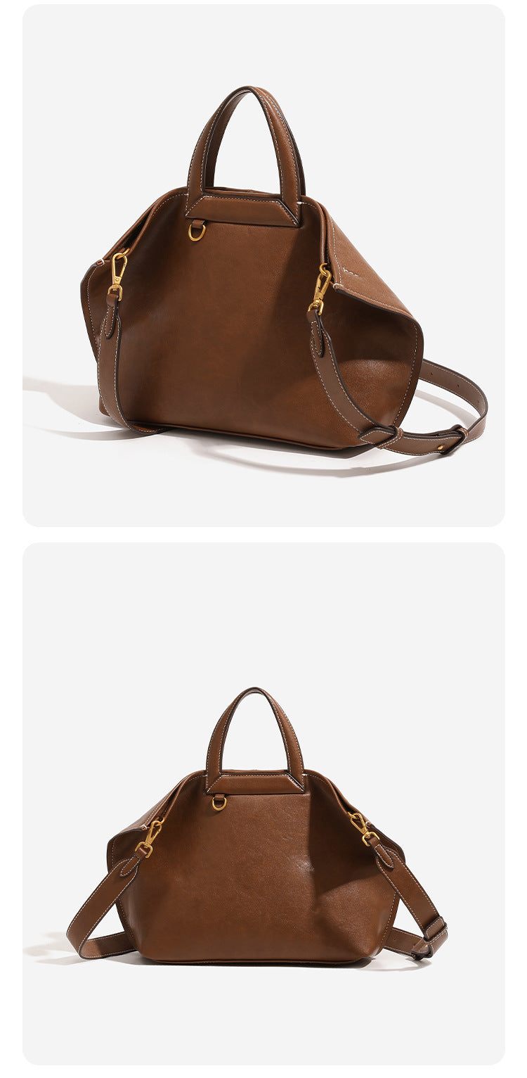 Structured cognac brown leather-look tote bag with fold-ear side panels, top handles, gold-tone hardware, and detachable