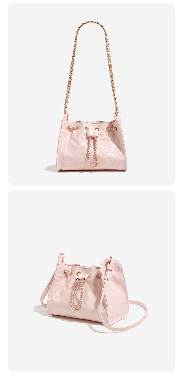 Glossy diamond-quilted drawstring bucket bag with gold-tone chain strap and eyelet hardware, detail view 12