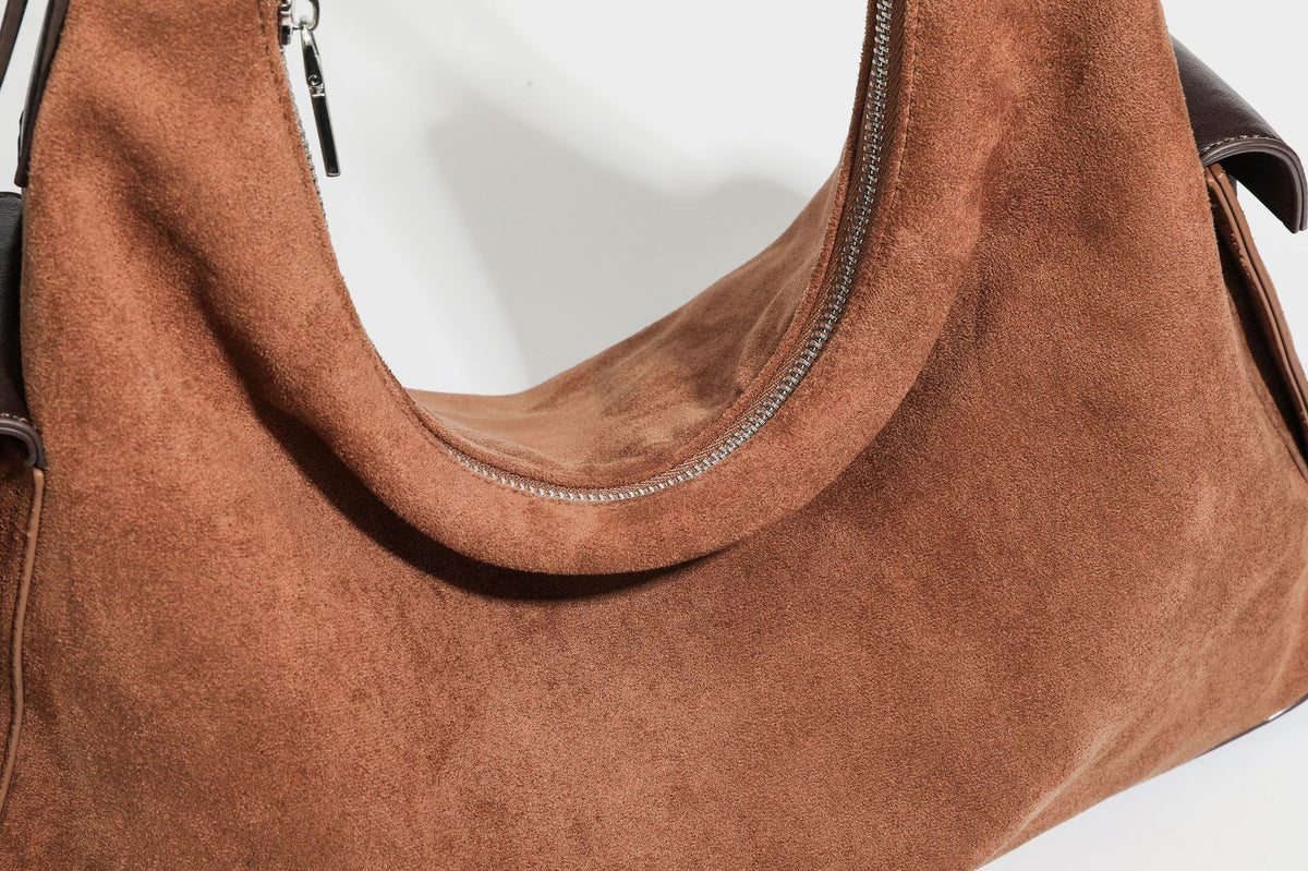 Slouchy cognac brown matte suede-look hobo shoulder bag with dark brown leather-look trim, top zip closure, front flap