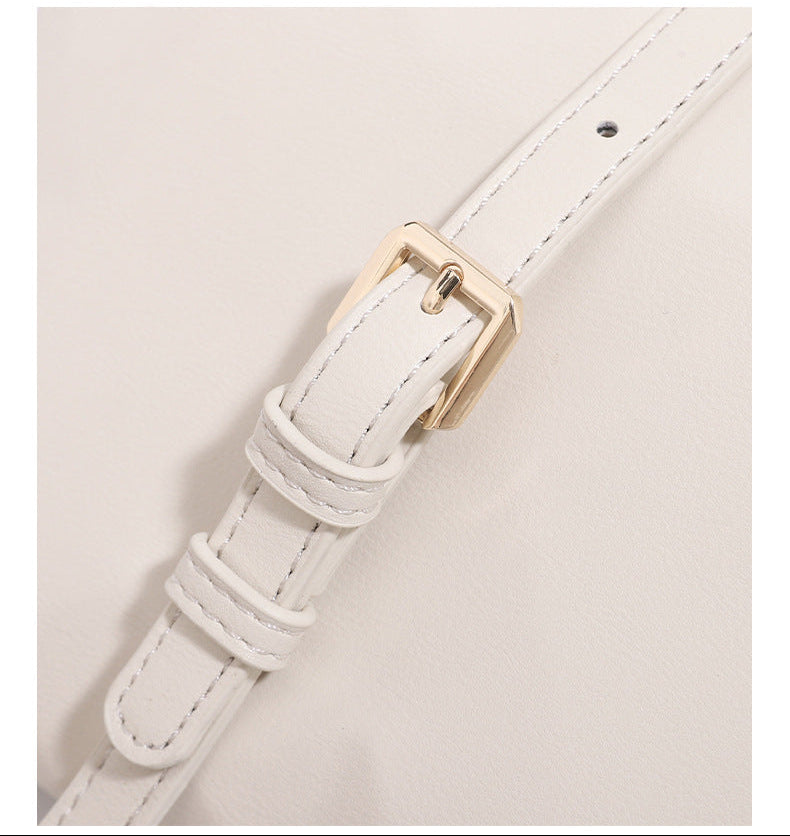 Geometric faceted flap shoulder bag with braided chain strap in black and ivory leather-look finish, detail view 13
