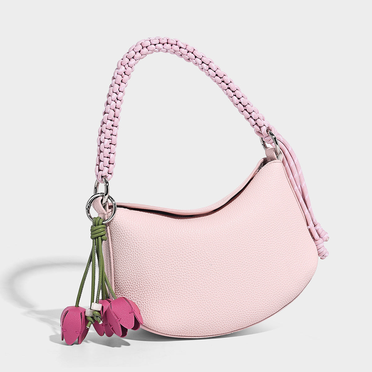 Small crescent half-moon bag in pebbled leather-look finish with braided top handle, silver-tone ring hardware, and, detail
