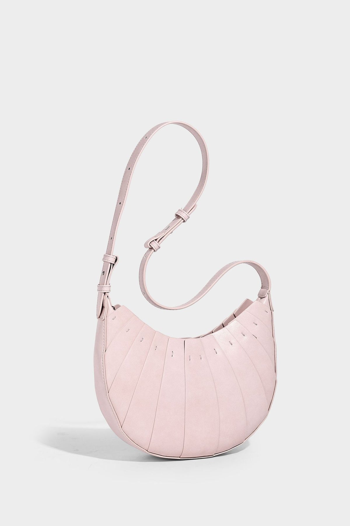 Crescent half-moon shoulder bag with vertical panel seaming, matte-satin leather-look finish, and adjustable gold-tone