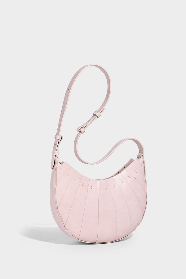 Crescent half-moon shoulder bag with vertical panel seaming, matte-satin leather-look finish, and adjustable gold-tone