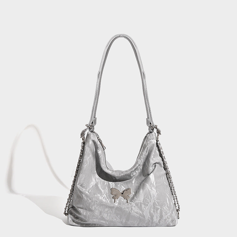 Crinkle-finish hobo shoulder bag with silver-tone chain side panels and butterfly embellishment, detail view 4
