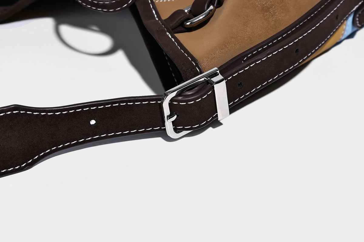 Patchwork bucket tote shoulder bag with tan, dark brown, olive, red, and sky blue color-block panels, white contrast, detail