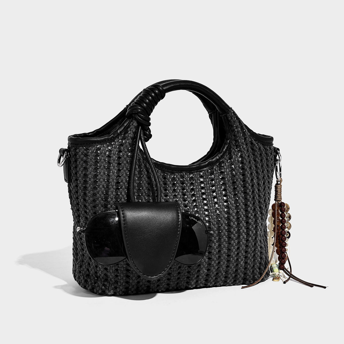 Small structured woven tote crossbody bag with ring top handle, leather-look brown trim, front patch pocket, and detachable