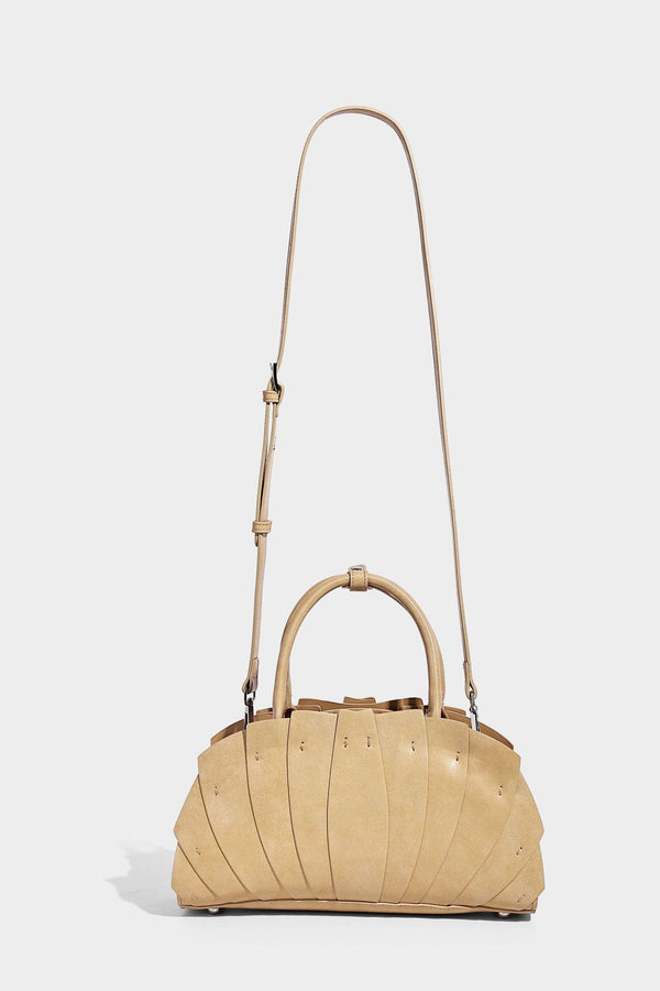 Structured dome satchel with fan-pleated leather-look exterior, dual top handles, and detachable shoulder strap, detail view