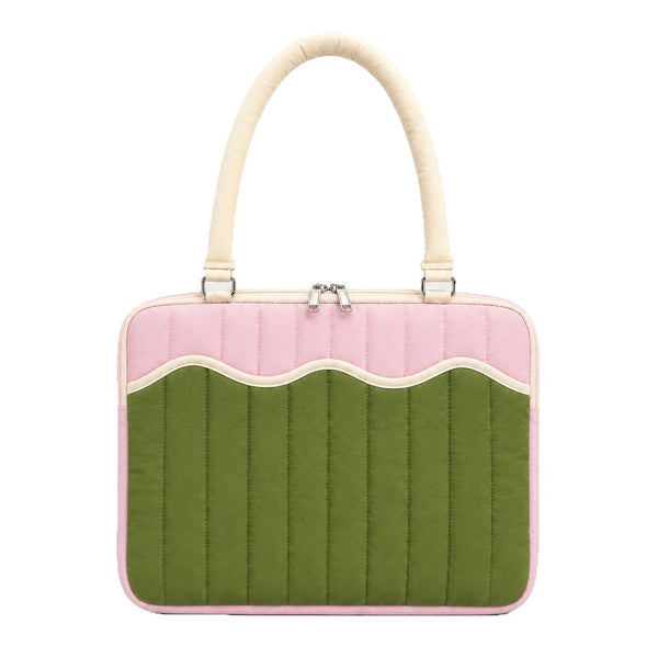 Quilted colorblock handbag with wavy scalloped front panel, padded arched top handles, and dual zip closure, detail view 5