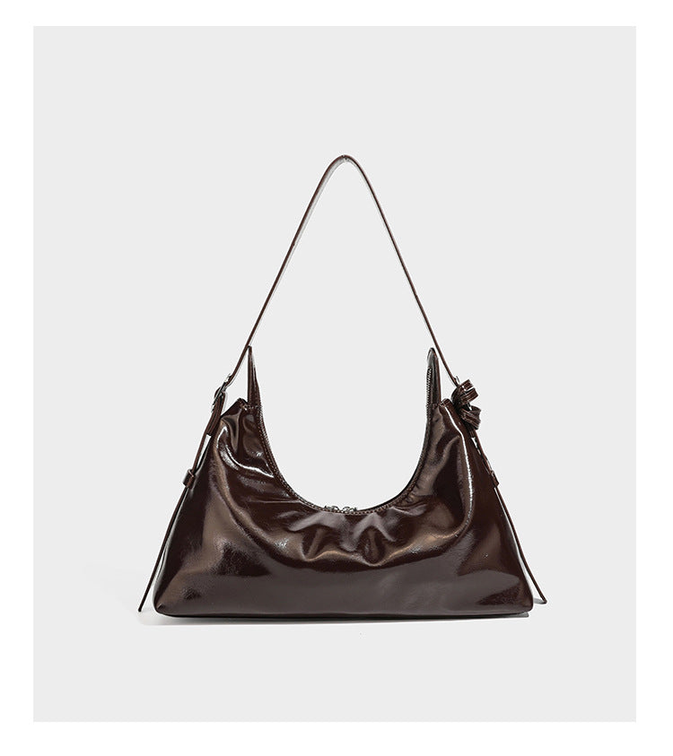 Glossy dark brown hobo shoulder bag with slim strap, front zip pocket, stud detail, and detachable leopard-print heart charm