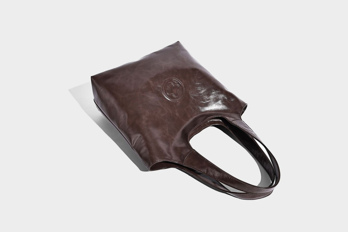 Glossy oil-wax leather-look open-top tote shoulder bag with embossed circular logo and long double straps, detail view 27