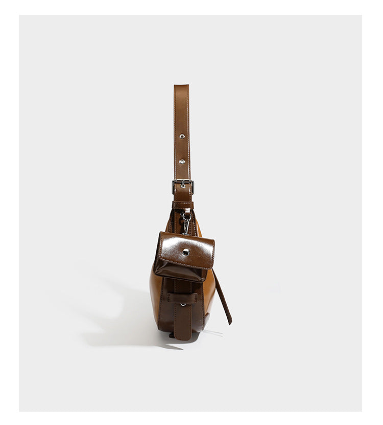 Glossy leather-look crescent hobo shoulder bag with dark contrast trim, silver-tone hardware, and attached mini flap pouch