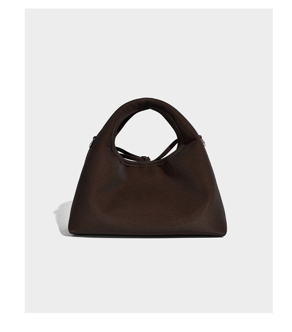 Pebbled matte trapezoid top-handle bag with drawstring bow closure, bead-tipped cords, silver-tone hardware, and detachable