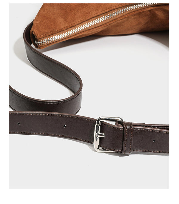 Cognac brown suede-look slouchy shoulder bag with dark brown leather-look trim, top zip closure, exterior side pocket, and