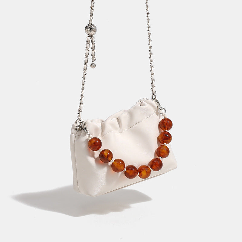 Ruched drawstring bucket bag with amber resin bead handle and silver-tone chain strap, detail view 3