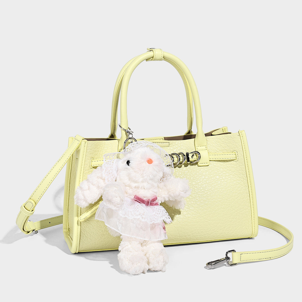 Structured trapezoid tote bag in pebbled leather-look finish with double top handles, silver-tone bar hardware, and, detail
