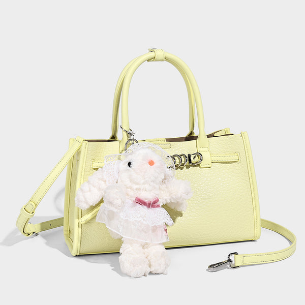 Structured trapezoid tote bag in pebbled leather-look finish with double top handles, silver-tone bar hardware, and, detail