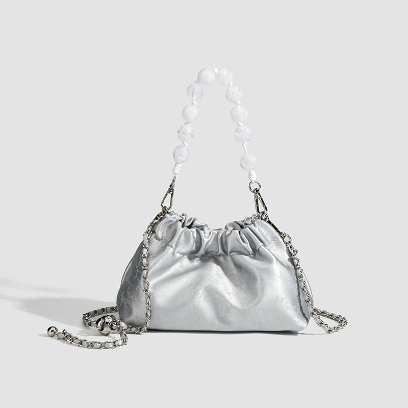 Small ruched drawstring pouch bag with pearl-bead handle and silver-tone chain strap, detail view 7
