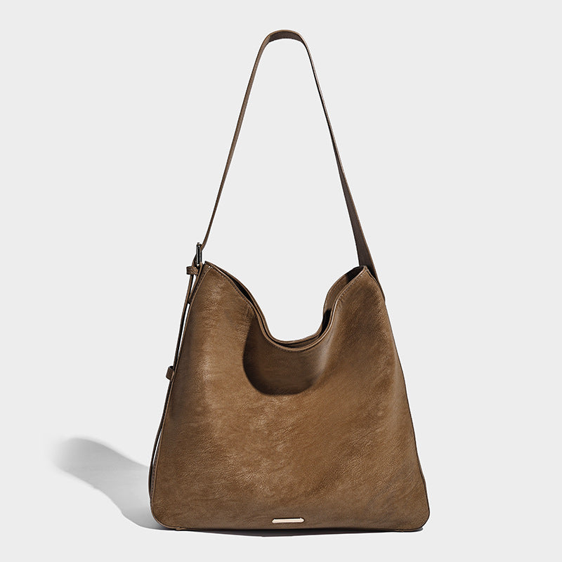 Large slouchy hobo shoulder bag in matte leather-look finish with adjustable strap and gold-tone bar hardware, detail view 3