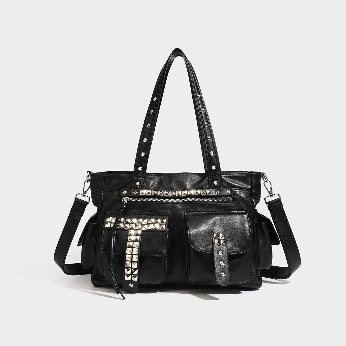 Black leather-look tote bag with silver pyramid studs on handles and front panel, multiple flap and zip exterior pockets