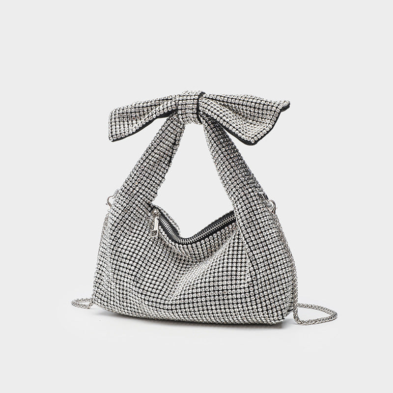 All-over rhinestone crystal bow shoulder bag with chain strap and zip closure, front view