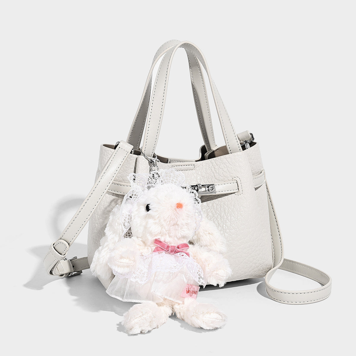 Small structured pebbled bucket tote with double top handles, silver turn-lock hardware, and detachable shoulder strap