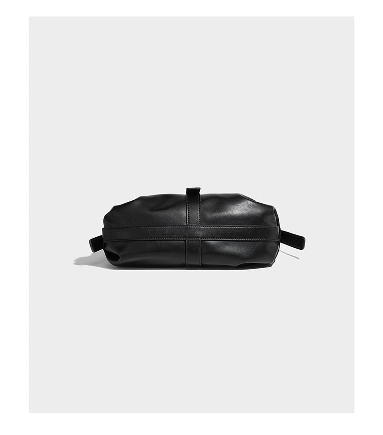 Soft slouchy hobo shoulder bag with smooth leather-look finish, gold-tone buckle and tab hardware, and long adjustable strap