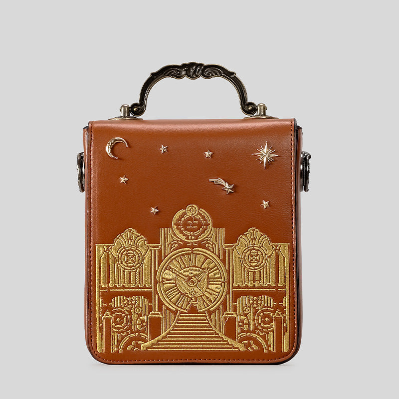 Small structured rectangular crossbody bag with ornate antique-style clock face and brass hardware in, detail view 2