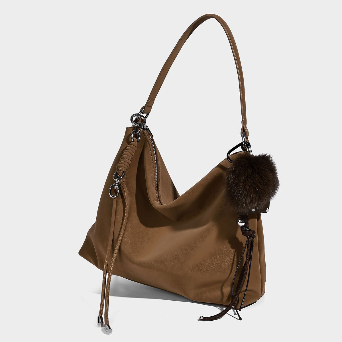 Slouchy matte-finish hobo shoulder bag with tassel cords, silver-tone hardware, and faux-fur pom charm, detail view 9