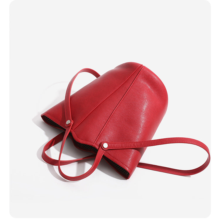 Large leather-look bucket tote bag with dual top handles and adjustable crossbody strap, detail view 16