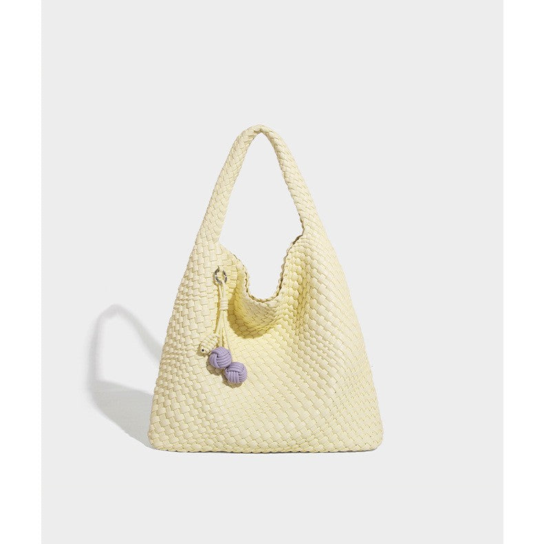 Soft hand-woven slouchy hobo tote bag with knotted tassel charm and single looped shoulder strap, front view
