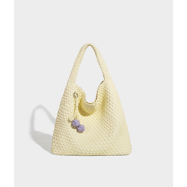 Soft hand-woven slouchy hobo tote bag with knotted tassel charm and single looped shoulder strap, front view