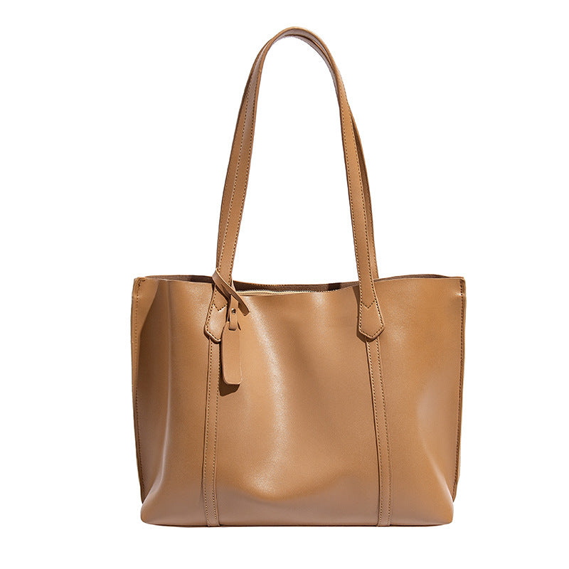 Large structured leather-look tote bag with belt-strap detail and gold-tone hardware, detail view 5