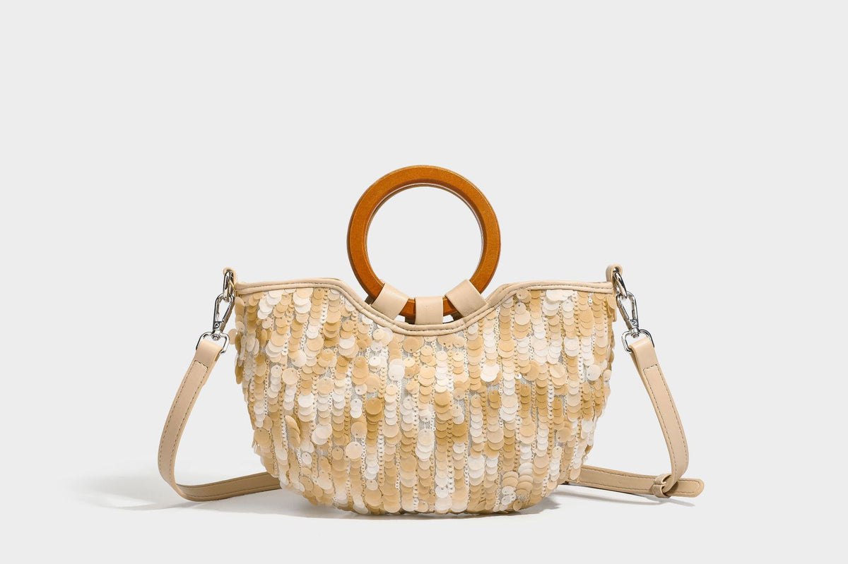 Small sequin half-moon handbag with circular wood-look ring handles and detachable leather-look shoulder strap, detail view