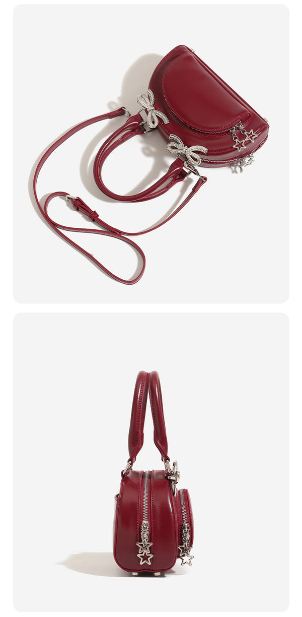 Structured half-moon mini handbag with silver-tone crystal bow hardware and star charm chain, detail view 10