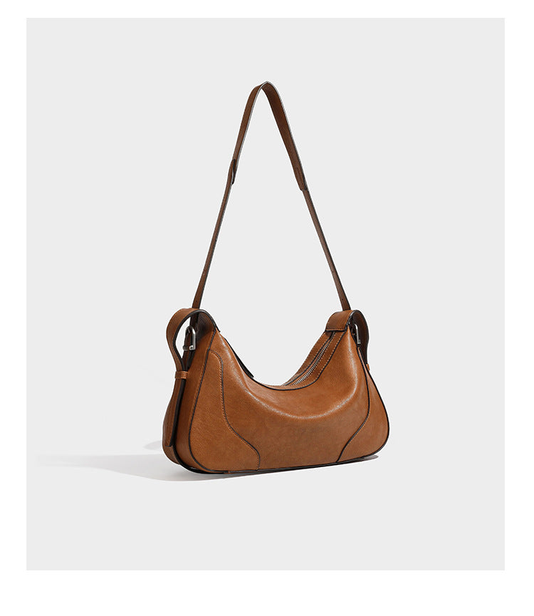 Slouchy crescent hobo shoulder bag in dark brown pebbled leather-look finish with zip top and long shoulder strap, detail