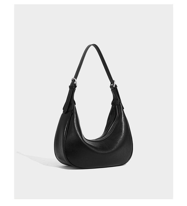 Crescent half-moon shoulder bag in pebbled leather-look finish with adjustable strap and silver-tone hardware, detail view 11