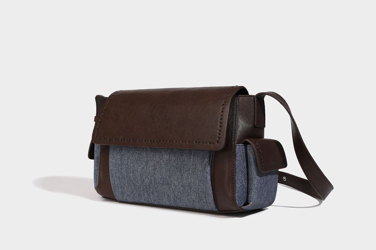 Structured flap crossbody bag in dark brown and cream color-block with white contrast stitching, adjustable shoulder strap