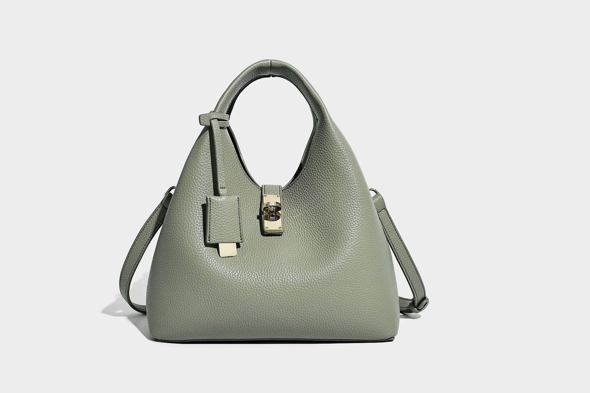 Structured pebbled-texture bucket bag with arched top handles, gold-tone turn-lock closure, and detachable shoulder strap