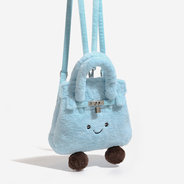 Ice-blue plush faux-fur Kelly-style convertible bag with embroidered smiling face, dark pom-pom feet, silver-tone clasp