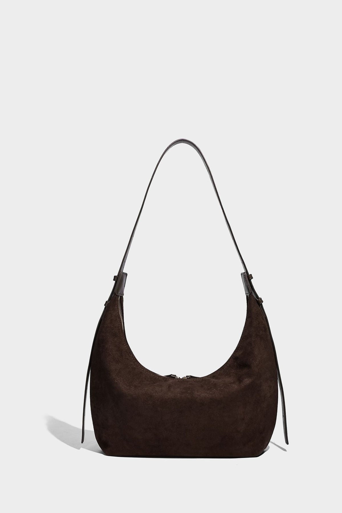 Slouchy crescent hobo shoulder bag in dark chocolate matte suede-look finish with adjustable strap and twin-pull top zip