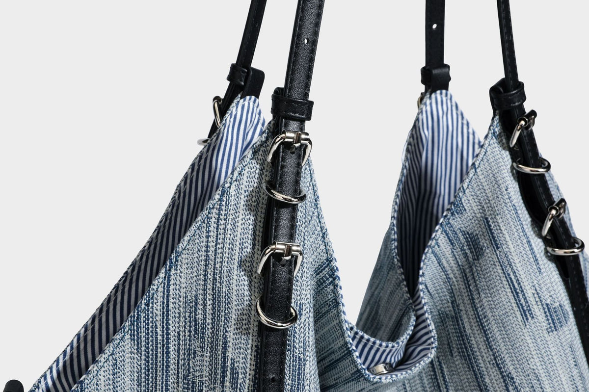 Large slouchy woven-texture shoulder tote bag with slim leather-look straps, side cinch ties, and silver-tone hardware