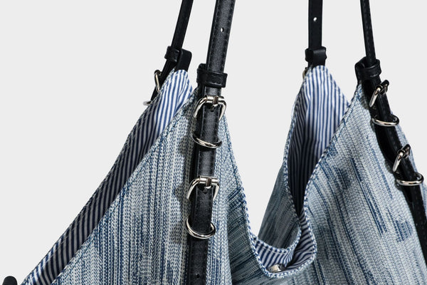 Large slouchy woven-texture shoulder tote bag with slim leather-look straps, side cinch ties, and silver-tone hardware