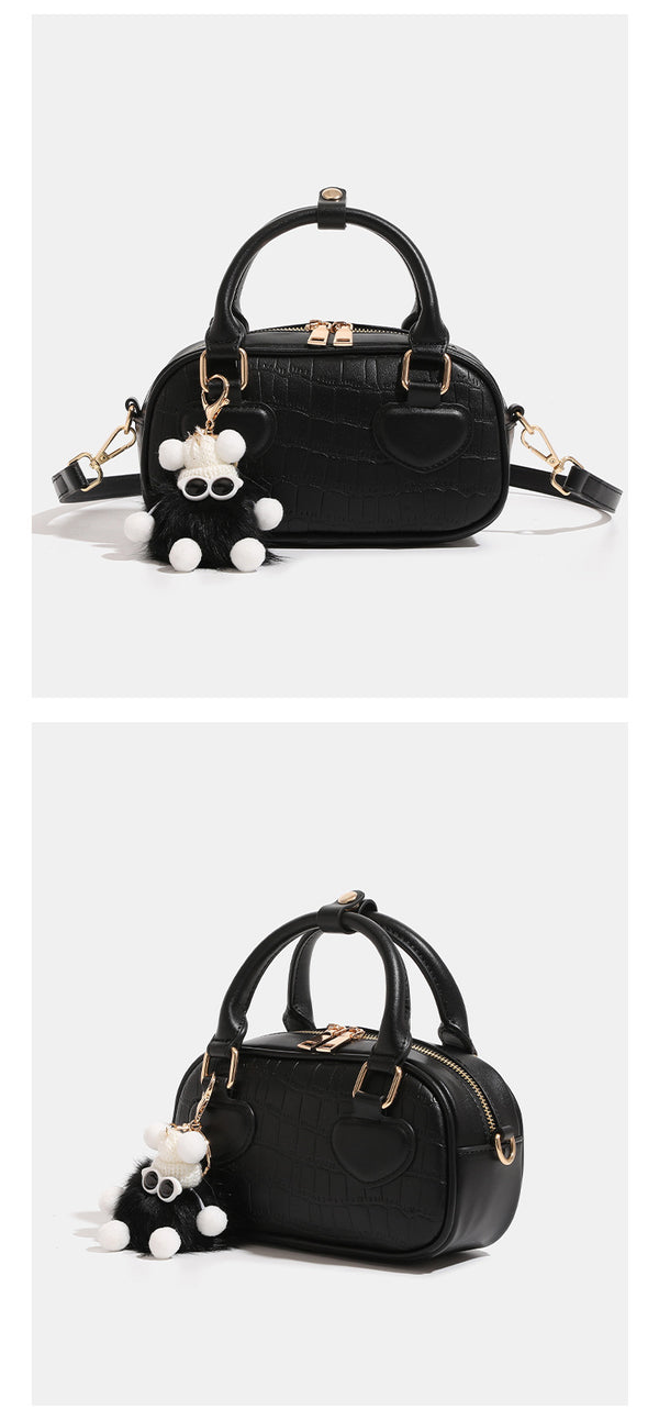 Mini croc-embossed barrel handbag with gold-tone hardware, dual zip top handles, detachable crossbody strap, and fluffy