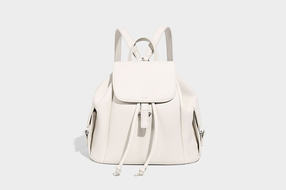 Compact pebbled leather-look flap drawstring backpack handbag with side pockets, top handle, and silver-tone hardware, detail