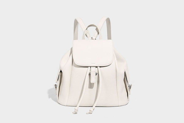 Compact pebbled leather-look flap drawstring backpack handbag with side pockets, top handle, and silver-tone hardware, detail