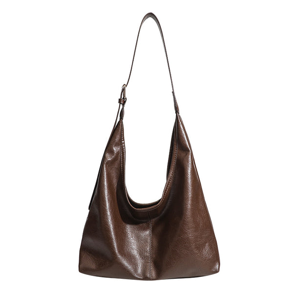 Large slouchy hobo shoulder bag in smooth leather-look finish with adjustable strap and gold-tone hardware, detail view 5