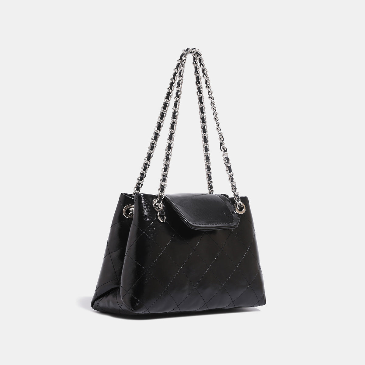 Quilted trapezoid shoulder bag with chain straps, flap closure, and ring hardware, detail view 3