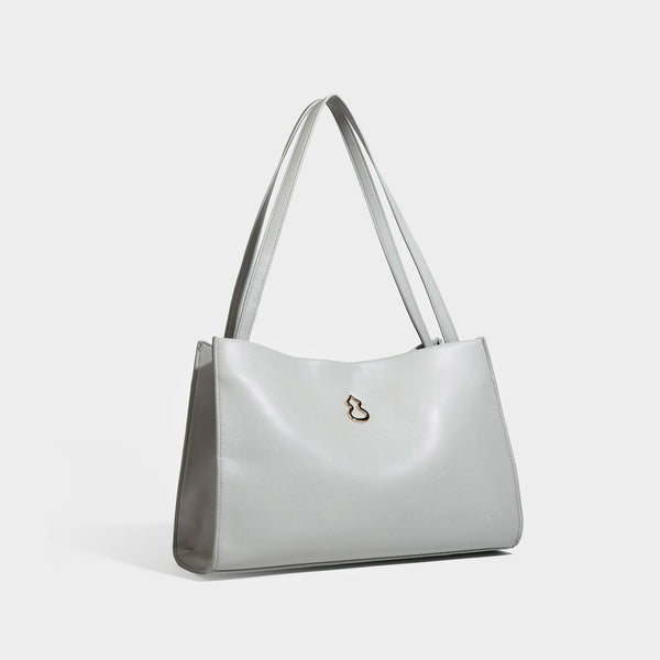 Structured rectangular shoulder tote bag with smooth leather-look finish, long double straps, and gold-tone gourd emblem on