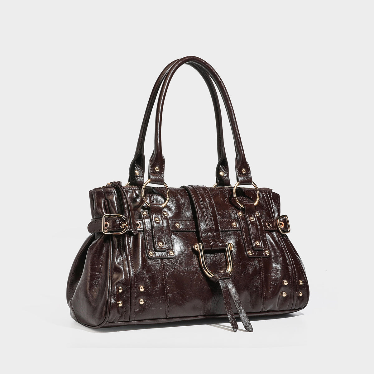 Glossy leather-look satchel bag with double top handles, gold-tone stud and ring hardware, front buckle strap detail, and